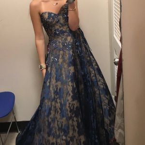 Long  navy blue over nude beaded prom dress.